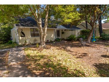 Quaint single-story home features a cozy front yard with mature trees providing ample shade at 1116 Daffodil Ln, Mount Pleasant, SC 29464