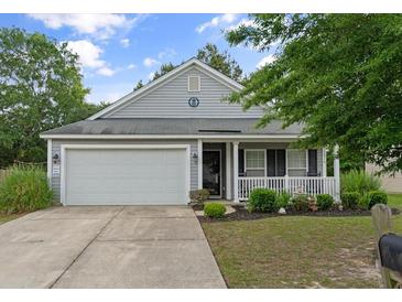 Charming home featuring a two-car garage, well-maintained lawn and attractive curb appeal at 1216 Wild Goose Trl, Summerville, SC 29483