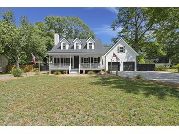 Charming two-story home featuring a welcoming front porch and well-maintained landscaping at 1260 Old Whitesville Rd, Moncks Corner, SC 29461