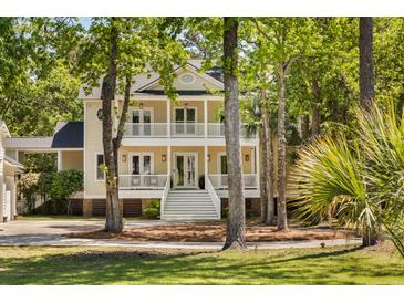 Charming two-story home with a welcoming double front porch and picturesque landscaping at 1505 Rivertowne Country Club Dr, Mount Pleasant, SC 29466