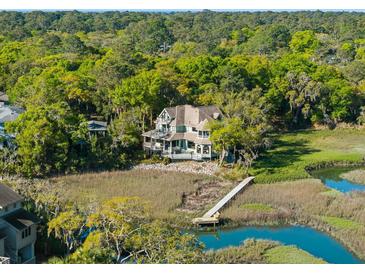Beautiful waterfront home nestled among lush trees with private dock and expansive views at 3104 Upda Creek, Seabrook Island, SC 29455