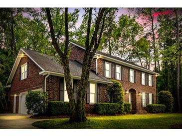 Stately brick home featuring manicured landscaping, symmetrical design, and an inviting entrance at 312 E Shepard Ln, Summerville, SC 29483