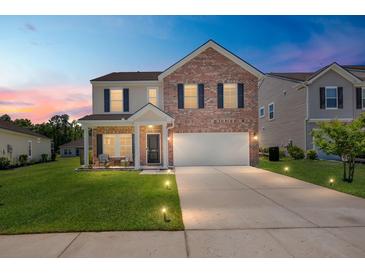 Charming two-story home with a brick facade, well-manicured lawn, and inviting front porch at 110 Levis Song Ct, Goose Creek, SC 29445