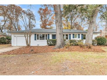 Charming single-story home with white brick, blue shutters, and a well-manicured front yard at 2462 Swallow Dr, Charleston, SC 29414
