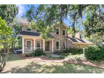 Exterior view of home with covered porch and lush landscaping at 3 Birmingham Ct, Charleston, SC 29407