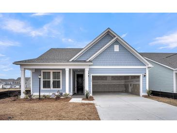 Charming single-Gathering home with a two-car garage and blue siding, under a clear, sunny sky at 321 Abercom Place Dr, Moncks Corner, SC 29461