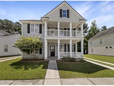 Charming two-story home with a welcoming double porch and manicured lawn, perfect for enjoying the outdoors at 529 Delafield Dr # 529, Summerville, SC 29483