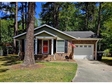 Charming brick home with an attached garage and a well-maintained lawn at 103 Bruce Ct, Summerville, SC 29486