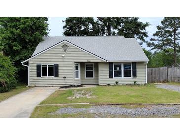 Charming single-story home with a well-manicured lawn and a classic design at 148 Lancashire Rd, Summerville, SC 29486