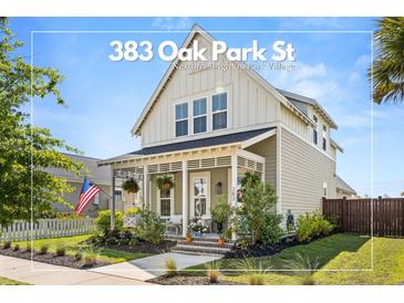 Charming two-story home with a quaint front porch and well-manicured landscaping at 383 Oak Park St, Summerville, SC 29486
