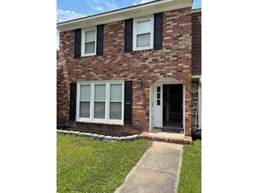 Charming two-story brick home featuring a well-manicured lawn and welcoming front entrance at 4324 Purdue Dr, North Charleston, SC 29418