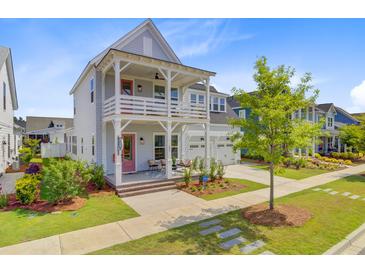 Charming two-story home with a double porch, a two-car garage, and a well-manicured lawn at 503 Ivy Green Ln, Summerville, SC 29486