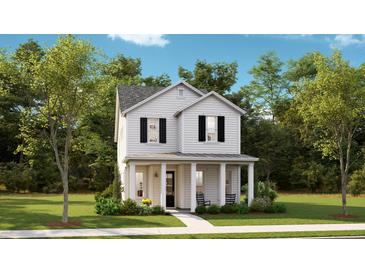 Charming two-story home with a welcoming front porch and well-maintained landscaping at 774 Clay Field Trl, Summerville, SC 29485