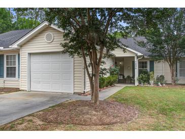 Charming single-story home with a well-maintained lawn, attached garage, and inviting front porch at 7896 Montview Rd, North Charleston, SC 29418