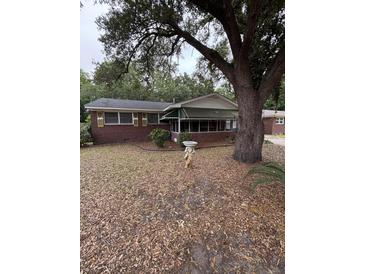 Charming one story brick home featuring a screened porch and mature trees at 1130 Yeamans Hall Rd, Hanahan, SC 29410