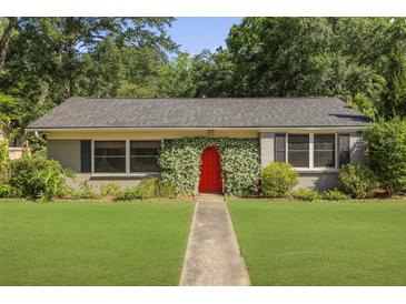 Charming home with a bright red front door and well-maintained lawn at 1522 Inland Ave, Charleston, SC 29412