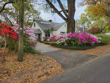Charming home featuring a driveway lined with beautiful azaleas at 2169 Westrivers Rd, Charleston, SC 29412