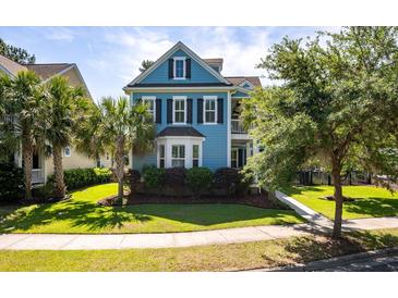 Charming blue two-story home featuring black shutters, lush landscaping, and a well-manicured lawn at 2627 Rutherford Way, Charleston, SC 29414