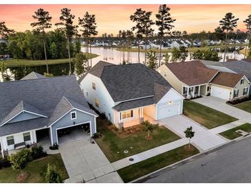 Stunning aerial view of lakeside homes with well-manicured lawns and a picturesque community at 327 Tupelo Lake Dr, Summerville, SC 29486