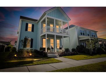 Charming two-story home with a double porch, showcasing a vibrant exterior paint under a beautiful dusk sky at 403 Cool Bend Ln, Summerville, SC 29486