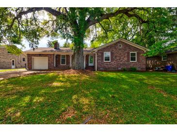 Charming brick home with a well-maintained lawn and mature trees offering plenty of shade at 4327 Bream Rd, North Charleston, SC 29418