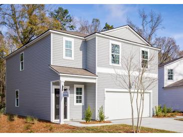 Charming two-story home featuring gray siding, a covered front porch, and an attached one-car garage at 601 Quiet Valley Rd, Summerville, SC 29486