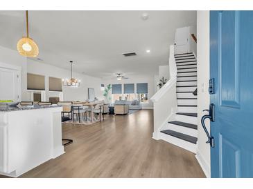 Bright, open-concept living space featuring modern decor and hardwood floors throughout the house at 105 Archdale St, Summerville, SC 29486