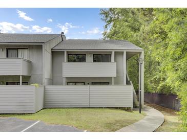 Charming exterior view of the home showcasing a fenced yard and a cozy balcony on the second floor at 108 Greenmeadow Dr, Goose Creek, SC 29445