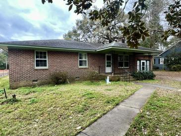Charming single-story brick home with a covered porch and mature trees at 113 Germantown Rd, Summerville, SC 29483