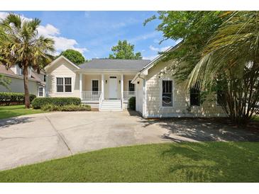 Inviting home with a quaint front porch, well-manicured landscaping, and spacious driveway at 1150 Quick Rabbit Loop, Charleston, SC 29414