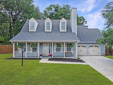 Charming home with a covered porch, dormer windows, and a well-manicured lawn at 1410 Diamond Boulevard, Mount Pleasant, SC 29466