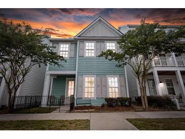 Charming two-story home featuring a quaint front porch and lovely curb appeal with verdant landscaping at 1661 Indy Dr, North Charleston, SC 29405