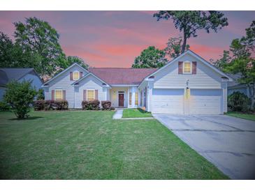 Charming single Gathering home with a well-manicured lawn and two-car garage nestled among mature trees at 217 Smithfield Ave, Summerville, SC 29485