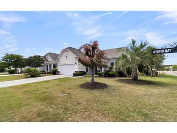 Charming single-story home in Oyster Bay, featuring a well-manicured lawn and mature trees at 318 Oyster Bay Dr, Summerville, SC 29486