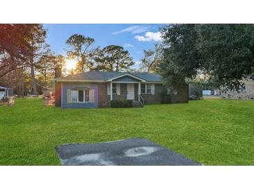 Charming single-story home with blue and brick exterior and lush green lawn at 33 Elliott Ct, Walterboro, SC 29488
