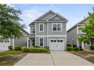 Charming two-story home with gray siding, manicured landscaping, and a private driveway at 3901 Poplar Grove Pl, Summerville, SC 29483