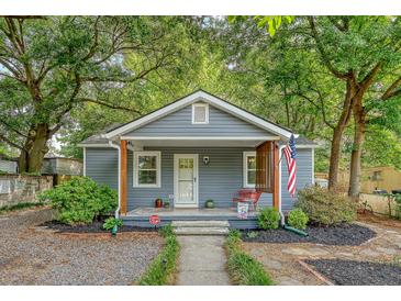 Charming single story home featuring a cozy front porch and a well maintained yard, offering an inviting curb appeal at 4546 Holly St, North Charleston, SC 29405