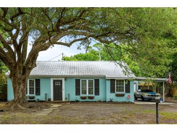 Charming home featuring a metal roof, updated windows, and a welcoming covered parking area at 532 Sunset Dr, Charleston, SC 29407