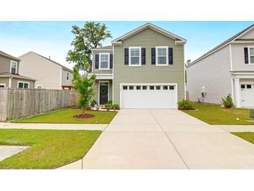 Charming two-story home featuring a two-car garage and well-manicured front lawn at 725 Pepperbush St, Charleston, SC 29414