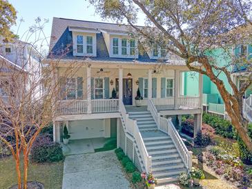 Charming home featuring a welcoming porch, multiple dormers and ground floor garage at 1141 Hills Plantation Dr, Charleston, SC 29412
