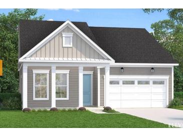 Charming single-story home showcasing stylish siding, a welcoming front porch, and an attached garage at 121 Summerwind Dr, Summerville, SC 29486