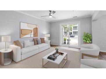 Bright living room with neutral tones, stylish furnishings, and sliding glass doors to outdoor area at 130 River Landing Dr # 4102, Charleston, SC 29492