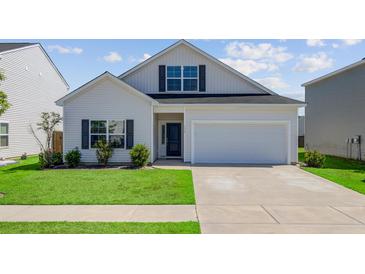Charming two-story home with a well-maintained lawn, a garage, and a classic architectural style at 134 Percheron Dr, Summerville, SC 29486