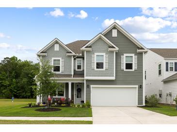 Charming two-story home with gray siding, white trim, a well-manicured lawn and an attached two-car garage at 167 Cherry Grove Dr, Summerville, SC 29483