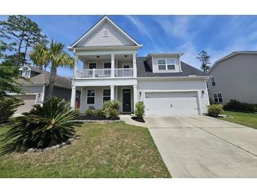 Charming two-story home with a front balcony, attached garage, and manicured landscaping enhancing its curb appeal at 203 Yeamans Way, Summerville, SC 29483