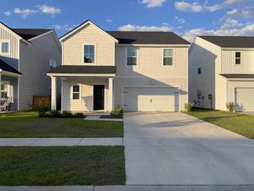 Charming two-story home boasts a well-manicured lawn and a two-car garage for modern comfort at 244 Tuscan Sun St, Summerville, SC 29485