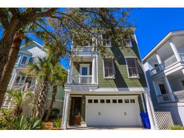 Charming two-story home with a garage and lush landscaping at 25 Ocean Point Dr, Isle of Palms, SC 29451