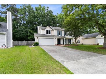 Charming two-story home featuring a well-maintained lawn, attached garage, and welcoming curb appeal at 332 Damascus Dr, Summerville, SC 29483