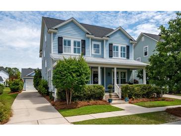 Charming light blue two-story home with a covered porch and well-manicured landscaping at 3656 Spindrift Dr, Mount Pleasant, SC 29466