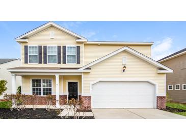 Charming two-story home with a black door, shutters and an attached two-car garage at 4021 Sanderson Ln, Summerville, SC 29483